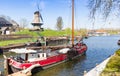 Old wooden sailing ship in front of the windmill in Gorinchem Royalty Free Stock Photo