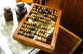 Old wooden scores. Hand on abacus . counter. retro calculator