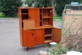 Old wooden secretaire thrown into the trash Royalty Free Stock Photo