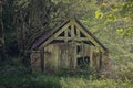 Ancient country wooden barn in woodland