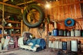 An old wooden shed on a remote cordon, with a tool for repairing equipment, with a group of old canisters and cylinders for Royalty Free Stock Photo