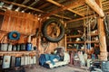 An old wooden shed on a remote cordon, with a tool for repairing equipment, with a group of old canisters and cylinders for Royalty Free Stock Photo