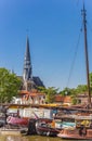 Old wooden ships and church tower in the harbor of Gouda Royalty Free Stock Photo