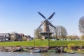Old wooden ships in front of the historic windmill in Gorinchem Royalty Free Stock Photo