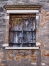 Old wooden shuttered window with faded paint