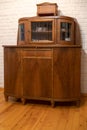 an old wooden sideboard against a white brick wall. Restoration of old furniture. Handmade repair of home furniture Royalty Free Stock Photo