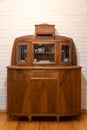 an old wooden sideboard against a white brick wall. Restoration of old furniture. Handmade repair of home furniture Royalty Free Stock Photo