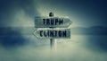 Old Wooden Sign on a Middle of a Cross Road With the Words Trump or Clinton