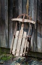 old wooden sled by wood barn Royalty Free Stock Photo