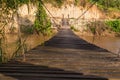 Old wooden sling brige hanging above river in northern Thailand Royalty Free Stock Photo