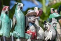 Old wooden souvenirs toys on the stone fence near the doll shop in Ubud, Bali island, Indonesia. Closeup