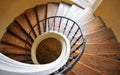 Wooden spiral staircase and light from the window Royalty Free Stock Photo