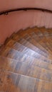 Old wooden spiral staircase with railing and shabby steps