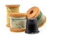An old wooden spool of thread and a needle on a white background close-up. Threads for sewing Royalty Free Stock Photo