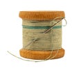 An old wooden spool of thread and a needle on a white background close-up. Threads for sewing Royalty Free Stock Photo