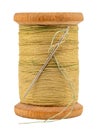 An old wooden spool of thread and a needle on a white background close-up. Threads for sewing Royalty Free Stock Photo
