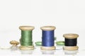 Old wooden spools of blue, green and black on an old, painted ta Royalty Free Stock Photo