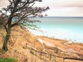 Old wooden stair way down with wooden hadrail, steps down to sea Royalty Free Stock Photo