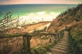 Old wooden stair way down with wooden hadrail, steps down to sea shore hill Royalty Free Stock Photo