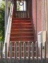 Old wooden stairway behind a fence leading upward