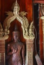 Old wooden statue in a buddhistic temple Royalty Free Stock Photo