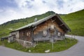 Old wooden and stone house in austrian mountains with deer antlers Royalty Free Stock Photo