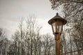 Old wooden street lamp outside in park village closeup electricity