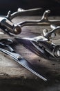 On a old wooden surface are old hairdresser tools. two vintage hand-held hair clipper and hairdressing scissors. vertical Royalty Free Stock Photo