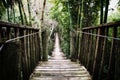 Old wooden suspension bridge over river