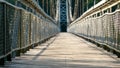 An old wooden suspension bridge over the river in the park. Wooden background for text. Autumn landscape Royalty Free Stock Photo