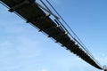 Old wooden suspension bridge on the sky background Royalty Free Stock Photo