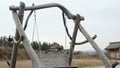 Old wooden swing hanging on ropes at open-air history and folklife museum