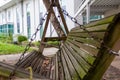 Side view of old swinging wooden bench in a park garden Royalty Free Stock Photo
