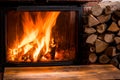 Old wooden table and fireplace with warm fire at the background Royalty Free Stock Photo