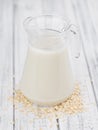 Old wooden table with fresh Oat Milk close-up shot; selective focus Royalty Free Stock Photo