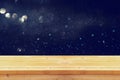 old wooden table in front of glitter lights background Royalty Free Stock Photo