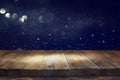 old wooden table in front of glitter lights background Royalty Free Stock Photo