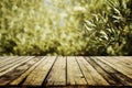 Old wooden table for product display with natural green olive field bokeh background. Natural vintage tabletop persepective and