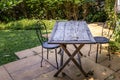 Old wooden table and two black steel chair for outdoor gardens Royalty Free Stock Photo