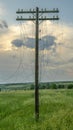 Old wooden Telegraph pole with cut electrical wires on sunset background Royalty Free Stock Photo