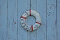 old wooden texture with a wooden life buoy white and red sea float