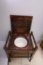 An old wooden toilet bowl, designed like chair Royalty Free Stock Photo