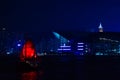 Old wooden tourist junk ferry boat in Victoria Harbor against famous Hong Kong island view with illuminated skyscrapers at night Royalty Free Stock Photo