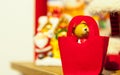 Old wooden toy bear red felt near of Christmas tree in the background other decorations and garlands. copy space. Royalty Free Stock Photo