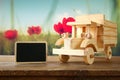 Old wooden toy car over wooden table. nostalgia and simplicity concept. vintage style image