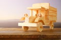 Old wooden toy car over wooden table. nostalgia and simplicity concept. vintage style image Royalty Free Stock Photo