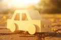 Old wooden toy car on the road outdoors in the park at sunset. nostalgia and simplicity concept. Royalty Free Stock Photo