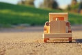 old wooden toy car on the road outdoors in the park at sunset Royalty Free Stock Photo