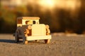 old wooden toy car on the road outdoors in the park at sunset Royalty Free Stock Photo