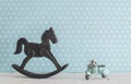 Old wooden toy horse rocking chair and blue vintage motorcycle Royalty Free Stock Photo